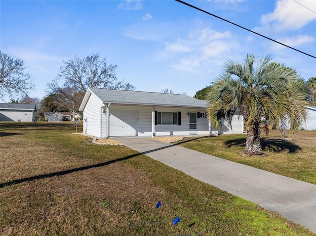 ranch-style home featuring covered porch, a garage, and a front yard