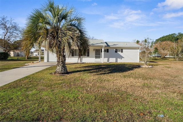 view of front of property with a front yard and a garage