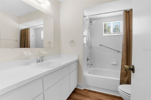 full bathroom with hardwood / wood-style floors, vanity, shower / bath combo, and toilet