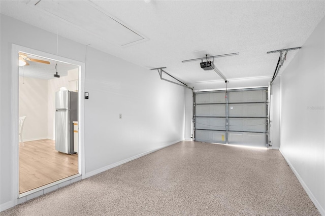 garage with stainless steel fridge, ceiling fan, and a garage door opener