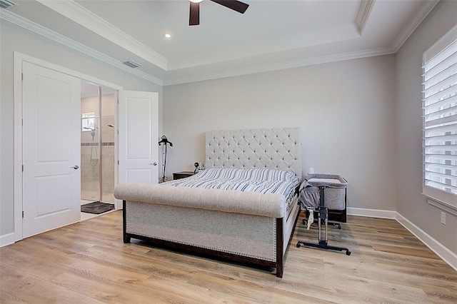 bedroom featuring a tray ceiling, ceiling fan, and light wood-type flooring