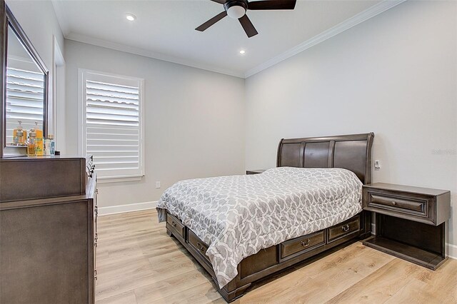 bedroom with ceiling fan, light wood-type flooring, and ornamental molding