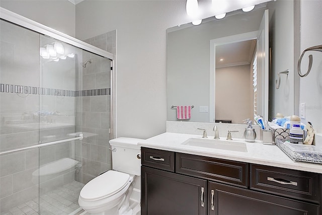 bathroom featuring an enclosed shower, vanity, and toilet