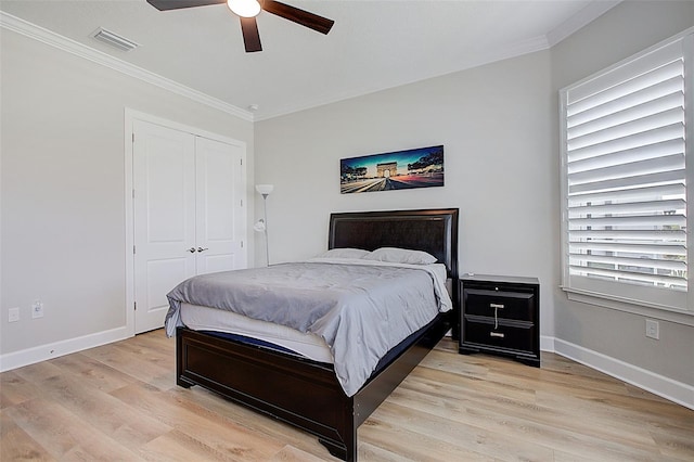 bedroom featuring multiple windows, a closet, ceiling fan, and light hardwood / wood-style floors