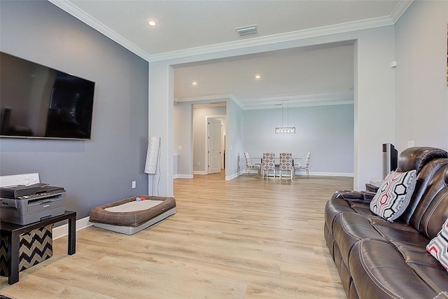 living room featuring light hardwood / wood-style floors and ornamental molding