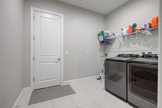 laundry area featuring light tile patterned floors and washer and clothes dryer