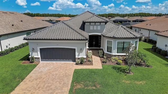 mediterranean / spanish-style home with a garage and a front yard