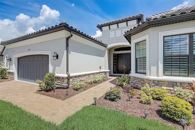 view of exterior entry featuring a garage