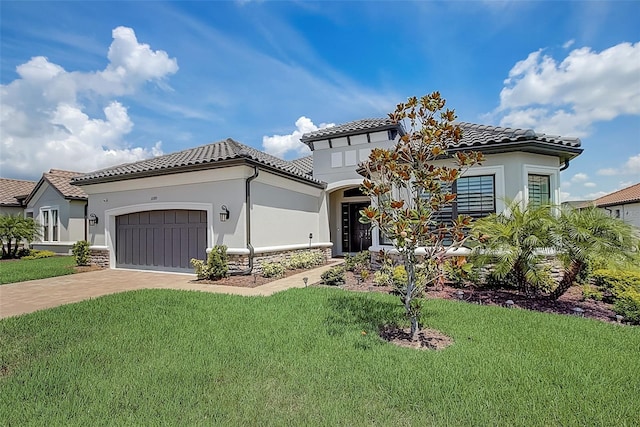 mediterranean / spanish house with a front yard and a garage