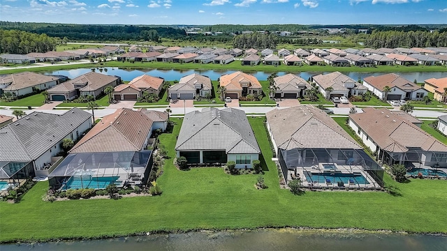 birds eye view of property with a water view