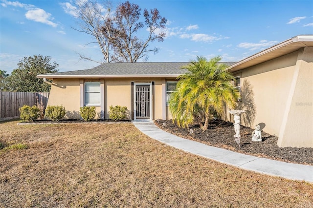 ranch-style home featuring a front yard