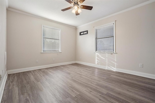 spare room with ceiling fan, dark wood-type flooring, and ornamental molding