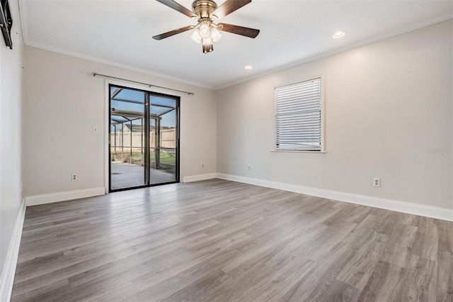 spare room featuring ceiling fan, light hardwood / wood-style floors, and crown molding