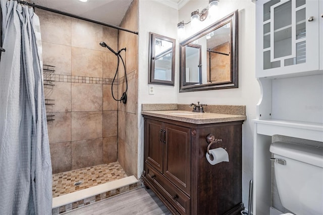 bathroom featuring toilet, hardwood / wood-style floors, walk in shower, and vanity