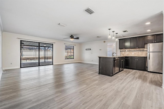 kitchen with ceiling fan, pendant lighting, light hardwood / wood-style flooring, and stainless steel refrigerator