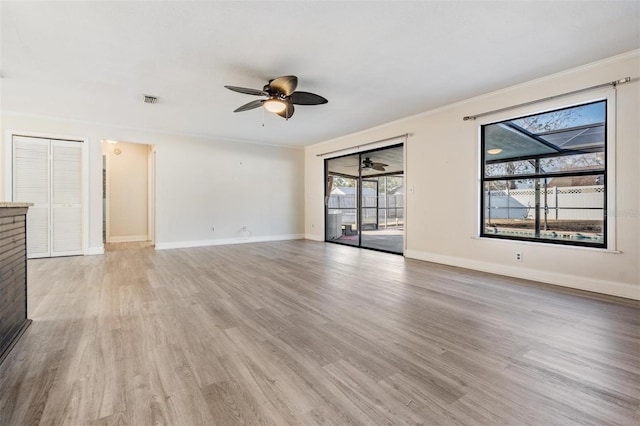 unfurnished living room with ceiling fan, wood-type flooring, and crown molding