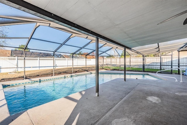 view of swimming pool with a patio area and glass enclosure