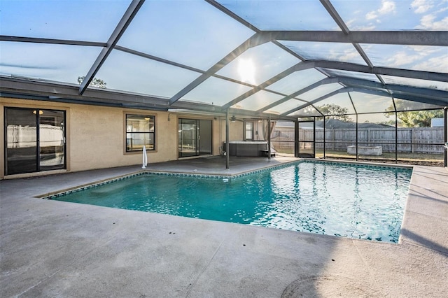 view of pool featuring glass enclosure and a patio area