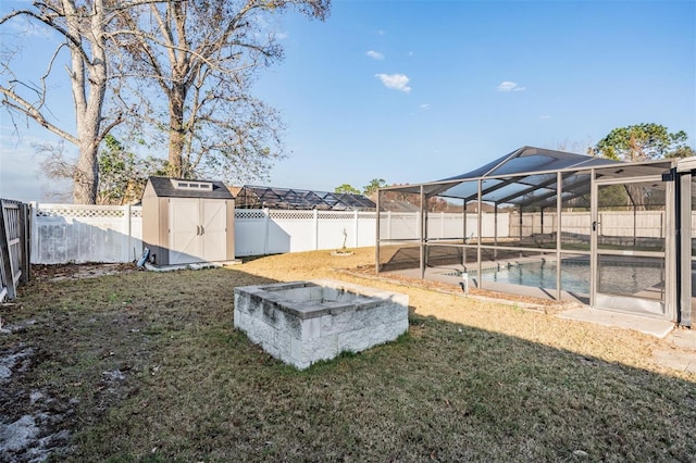 view of yard with a fenced in pool and a storage unit