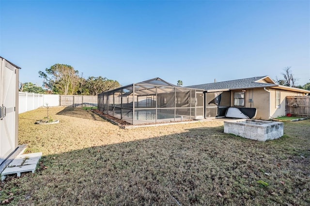 view of yard with a lanai and a fenced in pool