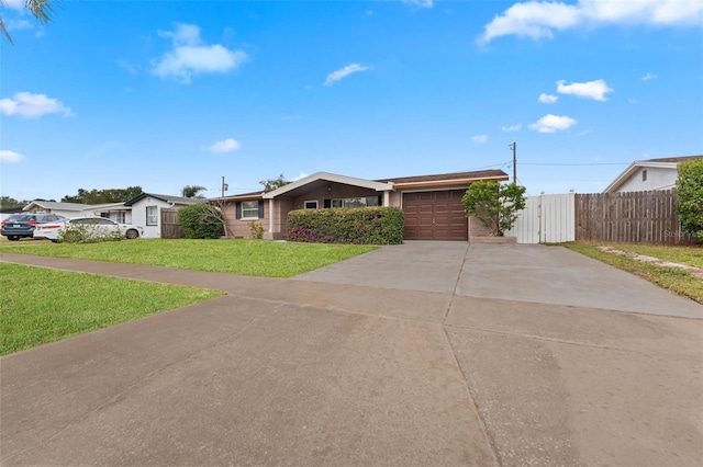 ranch-style house with a garage and a front lawn