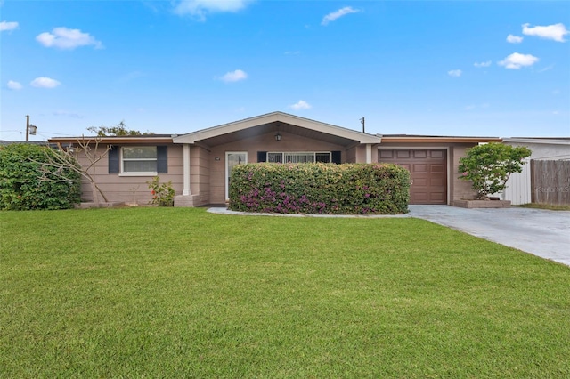 ranch-style home with a garage and a front lawn