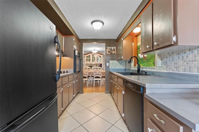 kitchen featuring backsplash, light tile patterned flooring, sink, and appliances with stainless steel finishes