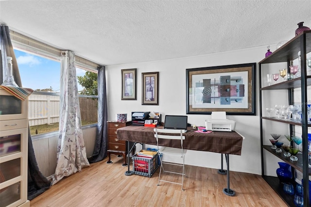 office featuring hardwood / wood-style flooring and a textured ceiling