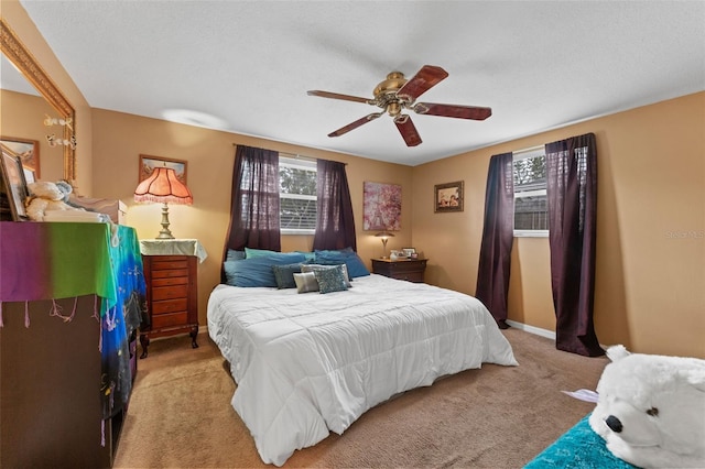 carpeted bedroom with multiple windows and ceiling fan