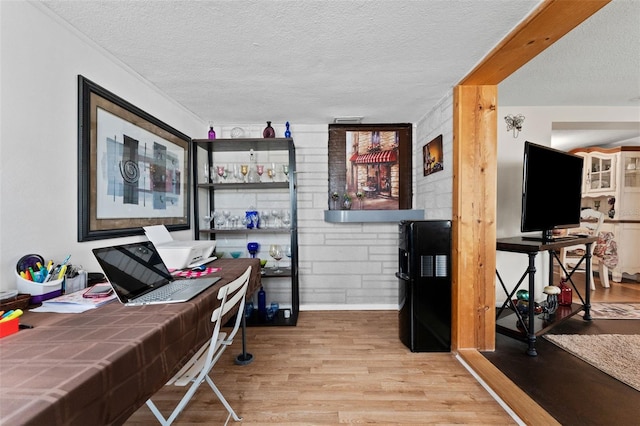 office space with a textured ceiling and light hardwood / wood-style floors