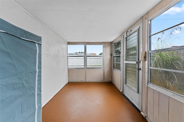 unfurnished sunroom featuring a healthy amount of sunlight