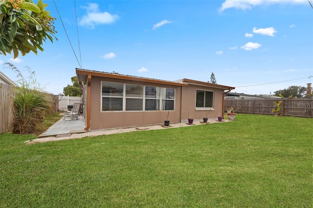 back of house with a lawn