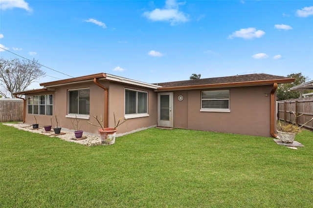 rear view of house featuring a lawn