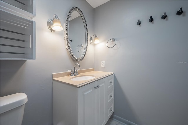 bathroom featuring vanity and toilet