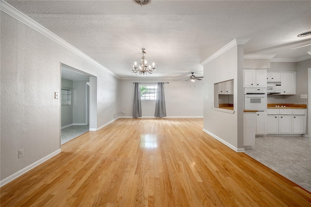 unfurnished living room featuring crown molding, ceiling fan with notable chandelier, light hardwood / wood-style flooring, and a textured ceiling