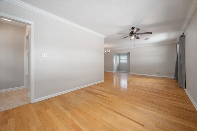 spare room with crown molding, ceiling fan with notable chandelier, and light hardwood / wood-style flooring