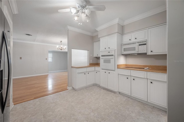 kitchen featuring white appliances, crown molding, white cabinetry, light hardwood / wood-style floors, and ceiling fan with notable chandelier