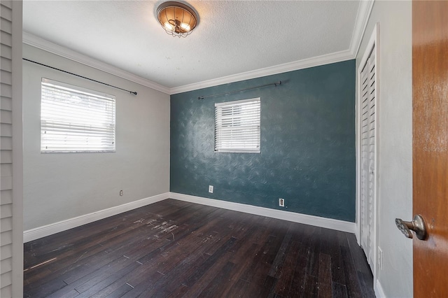 unfurnished room with crown molding, dark hardwood / wood-style floors, and a textured ceiling