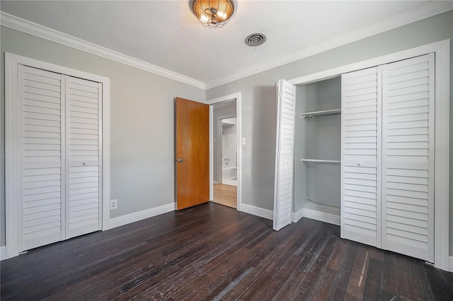 unfurnished bedroom featuring dark hardwood / wood-style flooring, ornamental molding, and a textured ceiling