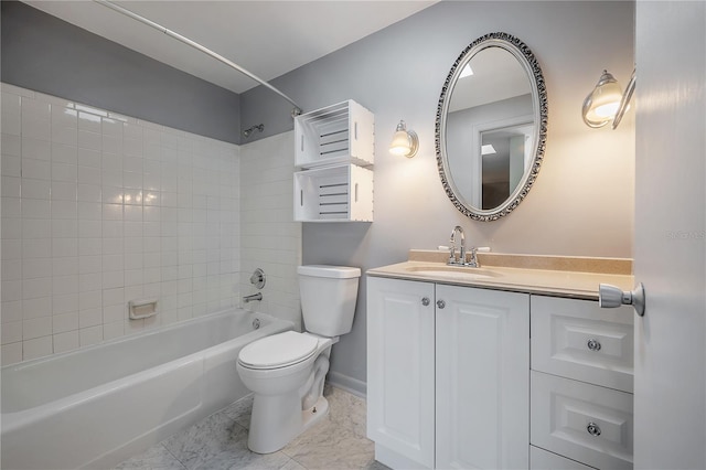 full bathroom featuring vanity, tiled shower / bath, and toilet