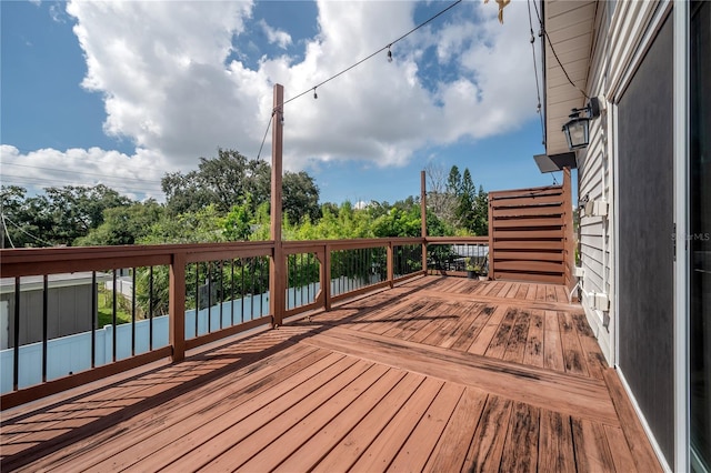 wooden terrace featuring a water view