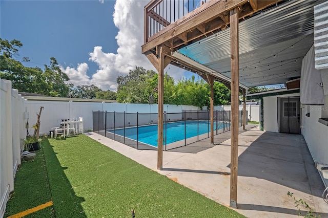 view of pool with a yard and a patio area