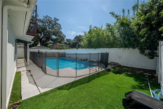 view of pool with a patio area and a lawn