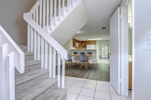 stairs with tile patterned floors