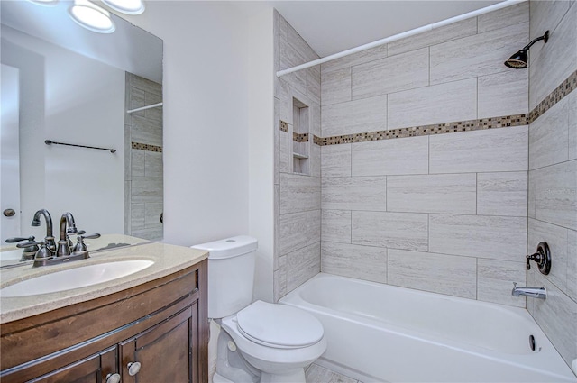 full bathroom featuring vanity, toilet, and tiled shower / bath combo