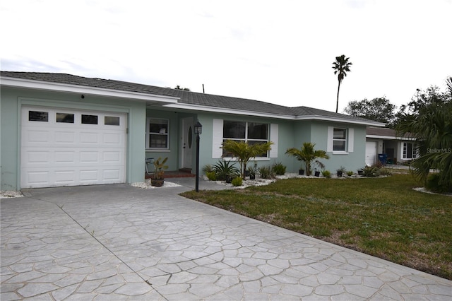 ranch-style house featuring a front yard and a garage