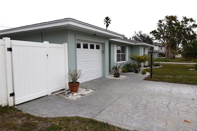 view of side of home with a yard and a garage