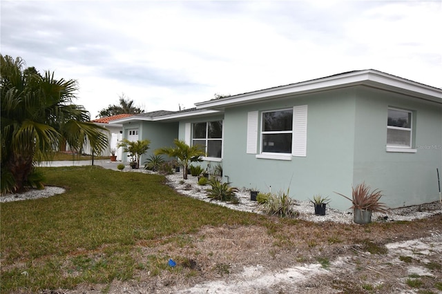 view of side of home featuring a yard