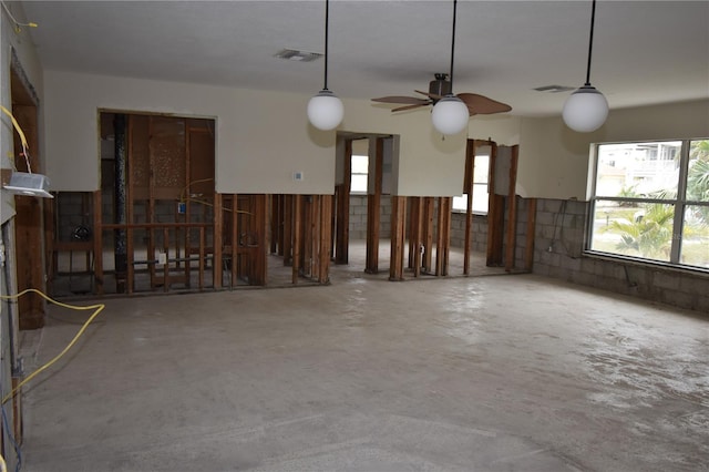 interior space with concrete floors and ceiling fan