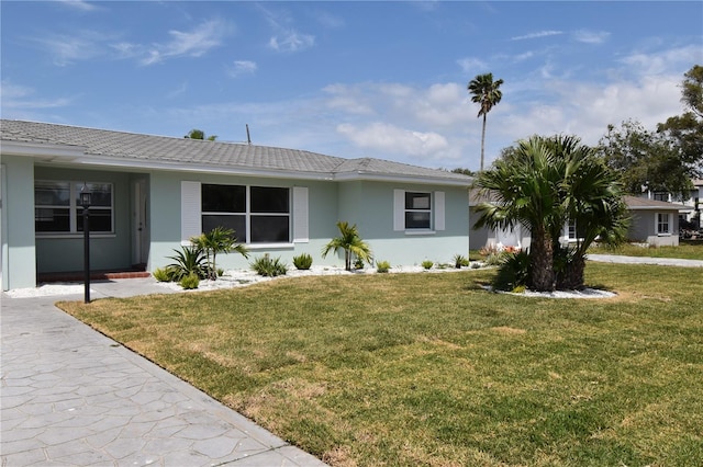 123 9th St, Belleair Beach, FL 33786 - ranch-style home featuring a front lawn and stucco siding